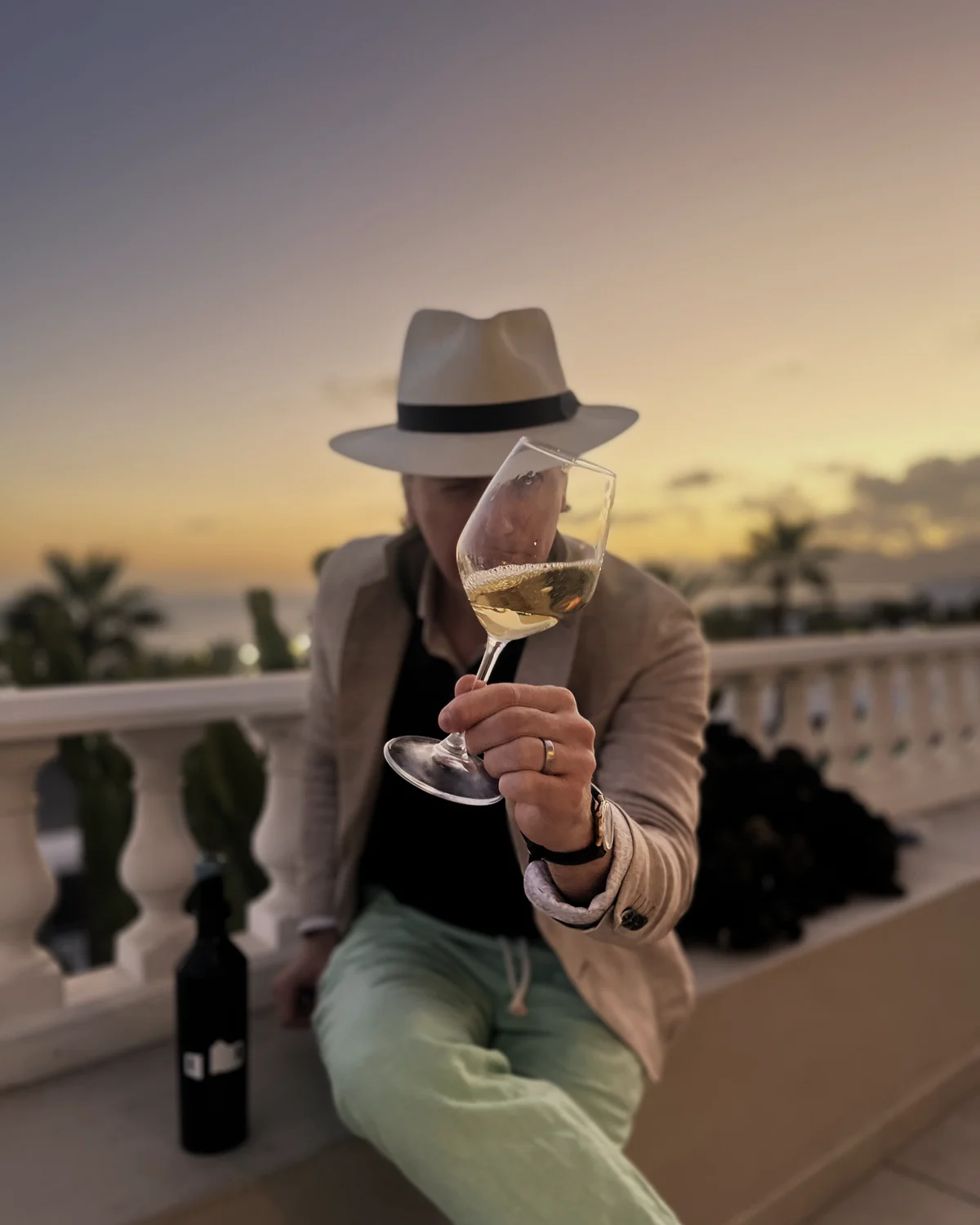 A glass against the sunset over the island