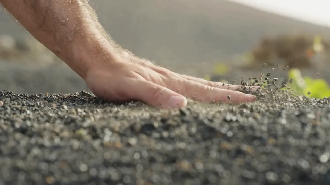 A hand in the picón on Althay’s land